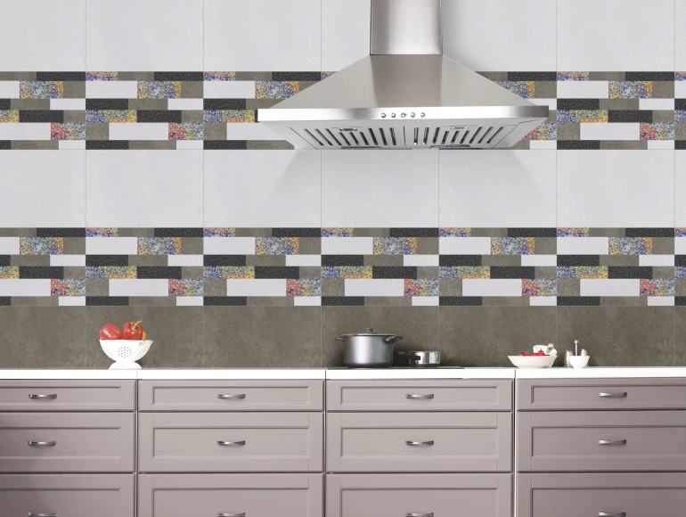 Contemporary kitchen featuring a multicolor brick-patterned tile backsplash design, grey cabinetry, and a sleek chimney.